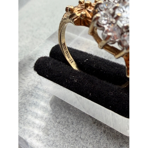 74 - A hallmarked 375 9ct gold ring with a CZ centre stone and Cz Halo. Size O. Weight 3.4g