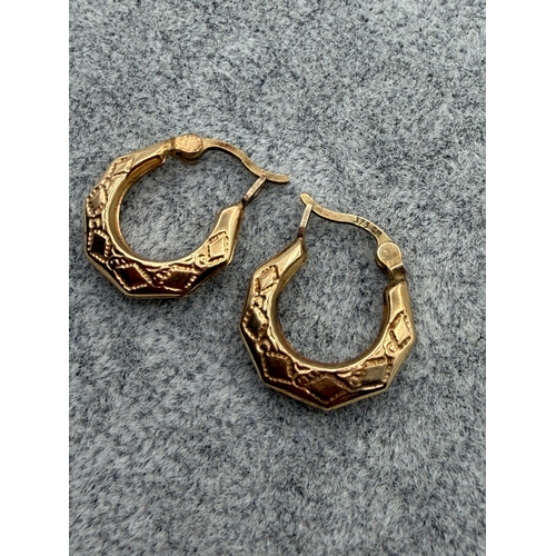 75 - A pair of stamped 375 9ct gold small hoop earrings.