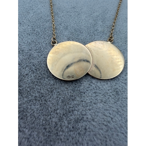 76 - A stamped 9ct gold double sovereign style necklace. Length 20 Inches. Weight 6.47g