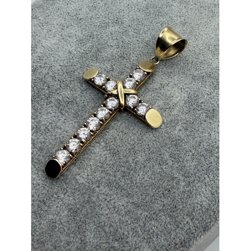 82 - A large 9ct Cross pendant with CZ stones.