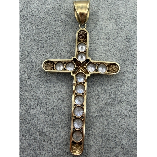 82 - A large 9ct Cross pendant with CZ stones.