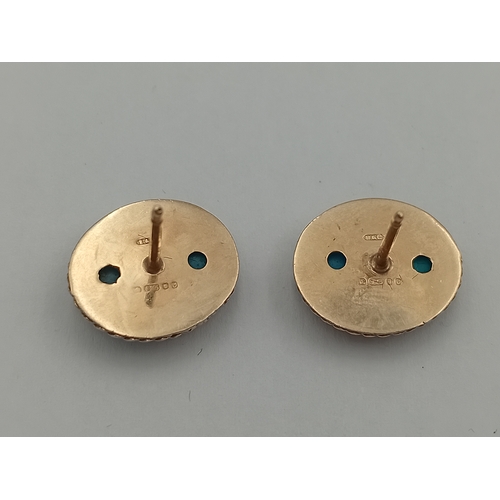 98 - A pair of stamped 375 9ct gold earrings set with turquoise stones.