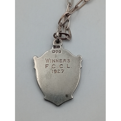 114 - An antique hallmarked silver fob medal with gold coloured cartouche hallmarked Chester, 1926, on cha... 