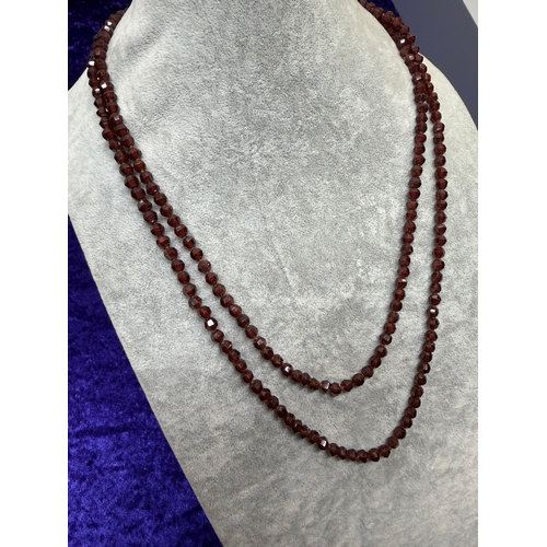 160 - An antique faceted garnet necklace featuring a 9ct gold clasp. Length 43.5 inches.