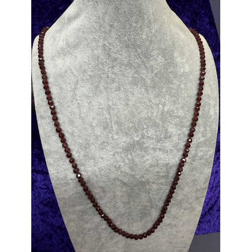 160 - An antique faceted garnet necklace featuring a 9ct gold clasp. Length 43.5 inches.