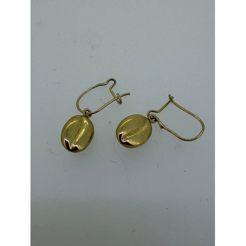 162 - A pair of tested 9ct gold coffee bean drop earrings.