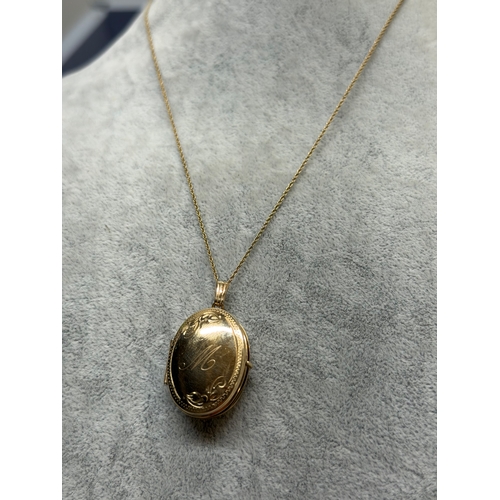 165 - A 9ct gold locket with a engraved floral pattern and an M monogram, fully hallmarked. Length 18 inch... 
