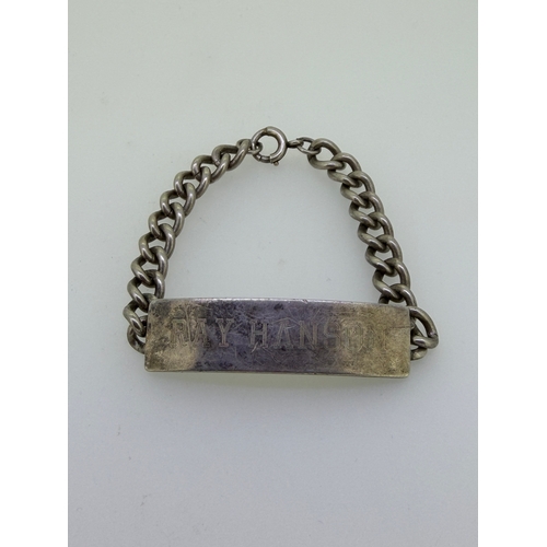 183 - A heavy Cuban link identity bracelet in sterling silver.