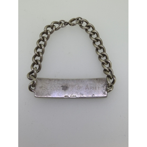 183 - A heavy Cuban link identity bracelet in sterling silver.