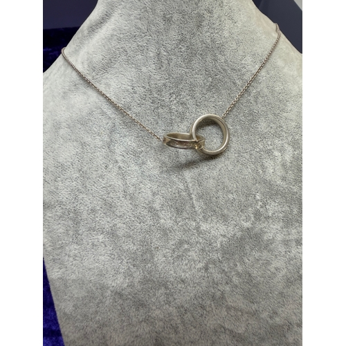 184 - A Tiffany and Co interlocking ring necklace with 925 stamp and Tiffany and Co chain link. Length 18