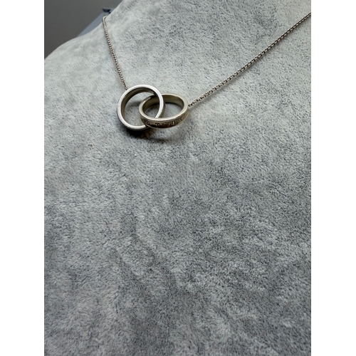 184 - A Tiffany and Co interlocking ring necklace with 925 stamp and Tiffany and Co chain link. Length 18