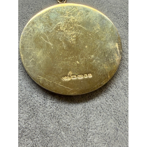 191 - A sterling silver medal featuring a black background with a gold enamel clock with words the worship... 