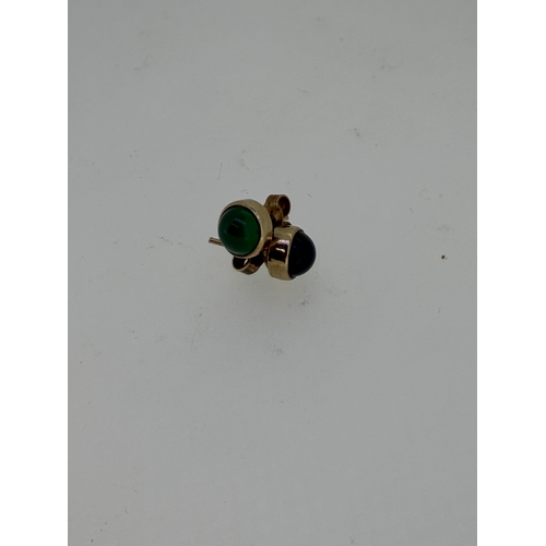 219 - A pair of 9ct yellow gold studs set with green onyx.