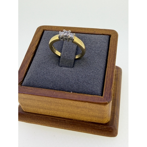 226 - A 18ct yellow gold engagement ring, set with a trio of emerald cut diamonds size J and 1/2. Weight 4... 