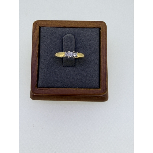 226 - A 18ct yellow gold engagement ring, set with a trio of emerald cut diamonds size J and 1/2. Weight 4... 