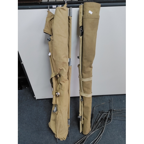 65 - A pair of military camp beds.