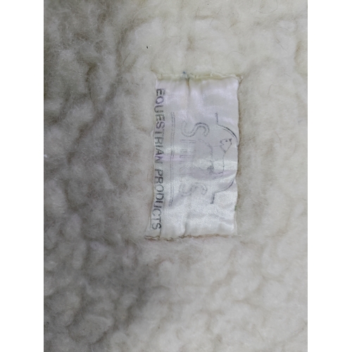 66 - A collection of 7 sheepskin wool saddle pads.