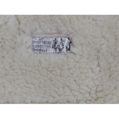 66 - A collection of 7 sheepskin wool saddle pads.