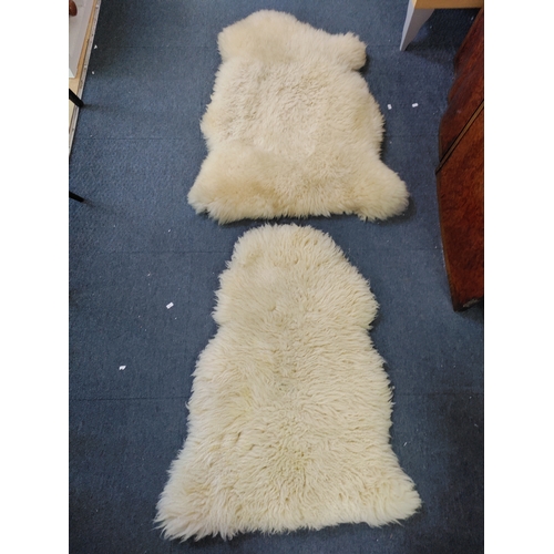 67 - A pair of sheepskin rugs.