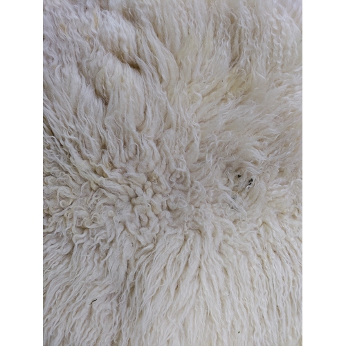 67 - A pair of sheepskin rugs.