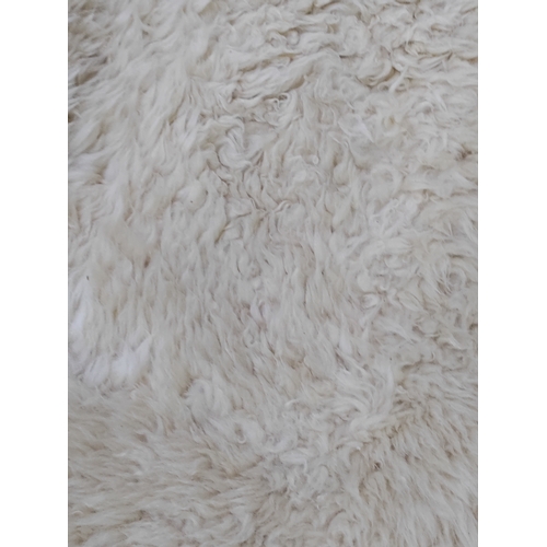 67 - A pair of sheepskin rugs.