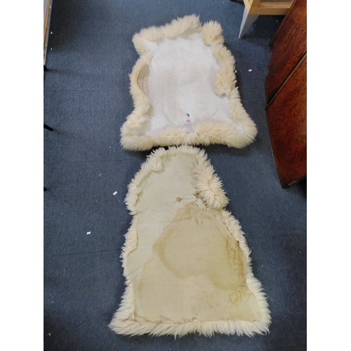 67 - A pair of sheepskin rugs.
