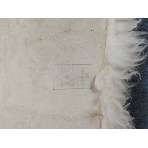 67 - A pair of sheepskin rugs.