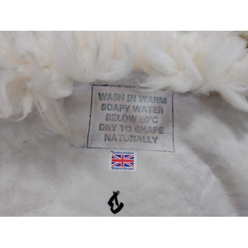 67 - A pair of sheepskin rugs.
