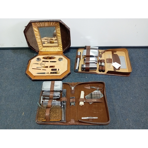 82 - A trio of vintage Men's grooming sets. To include Real pigskin & cowhide cases.