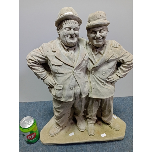 84 - A stone cast garden statue of the famous comedy duo Laurel and Hardy. Height 21.5
