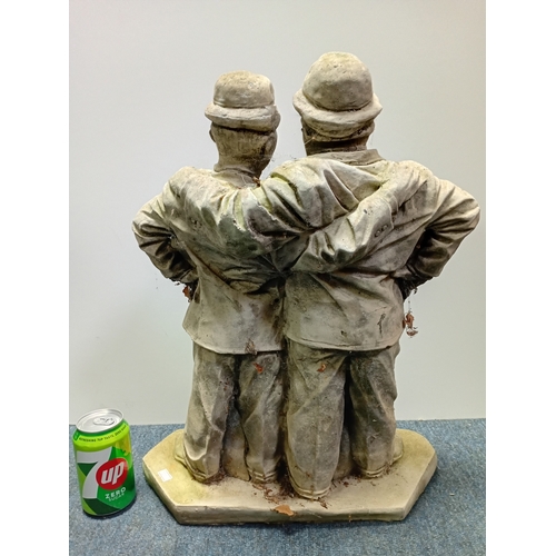 84 - A stone cast garden statue of the famous comedy duo Laurel and Hardy. Height 21.5