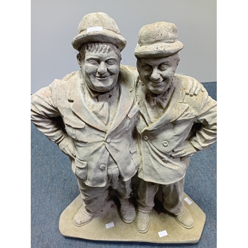 84 - A stone cast garden statue of the famous comedy duo Laurel and Hardy. Height 21.5