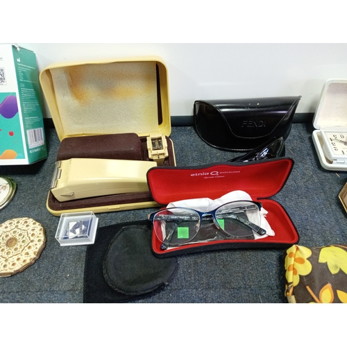 91 - A collection of Glasses & powder compacts. To include Stratton powder compacts, hair trimmers etc...