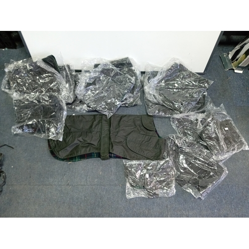 92 - A collection of 20  Barbour style waxed dog jackets. In various sizes.