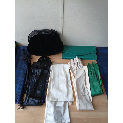 97 - A job lot of vintage women's accessories, to include; silk gloves, a purse, a bag, and table runners... 