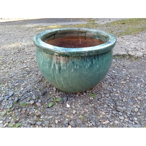 118 - A large green glazed ceramic pot. (Height 33 cm x Diameter 51 cm)