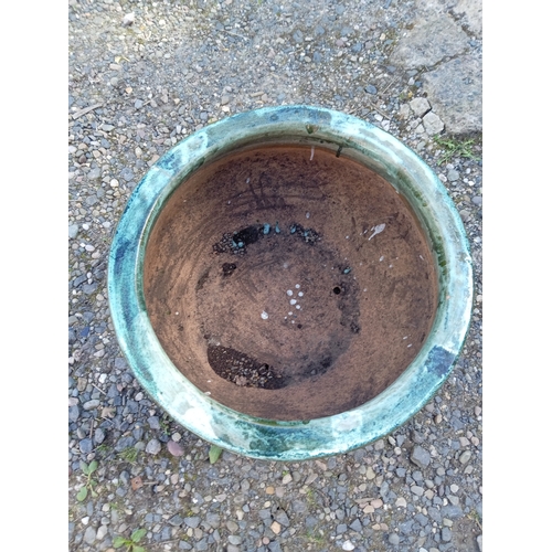118 - A large green glazed ceramic pot. (Height 33 cm x Diameter 51 cm)