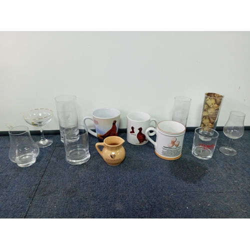 10 - A collection of mugs & glasses. To include brands The famous grouse, babycham, glenmorangie, Grants ... 