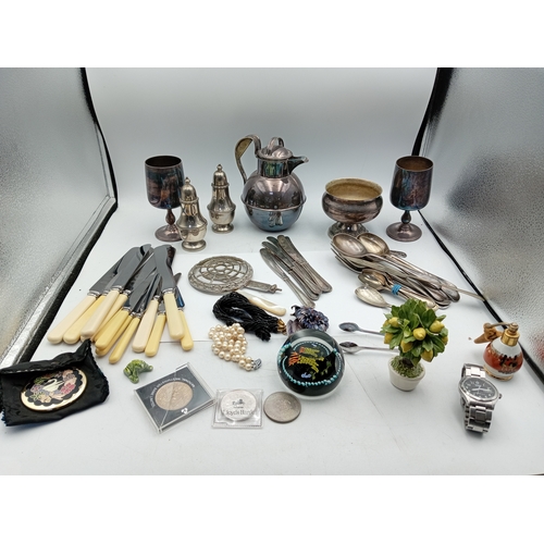 13 - A box of odds. To include Silver plate, glass paper weight, cutlery, Lorus men's wrist watch, etc...