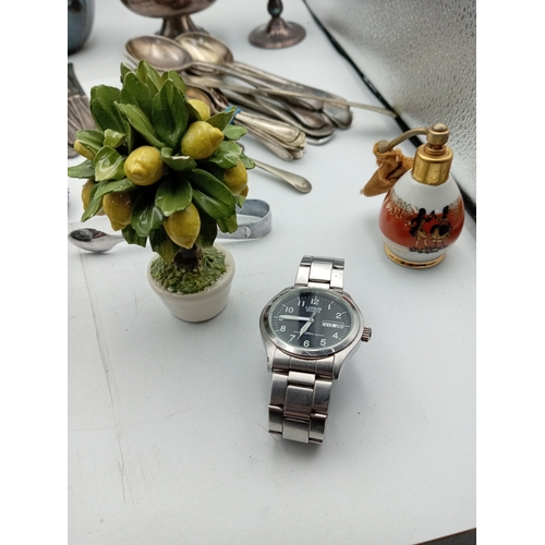 13 - A box of odds. To include Silver plate, glass paper weight, cutlery, Lorus men's wrist watch, etc...