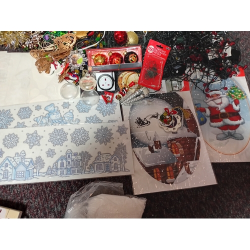 17 - A job lot of Christmas decorations. Featuring, lights, tree decorations, window stickers, an LED Wav... 