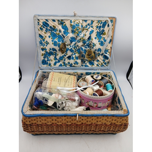 22 - A woven basket full of an assortment of sewing materials and accessories including scissors, needles... 