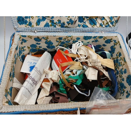 22 - A woven basket full of an assortment of sewing materials and accessories including scissors, needles... 