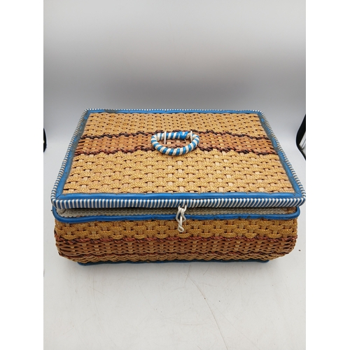 22 - A woven basket full of an assortment of sewing materials and accessories including scissors, needles... 