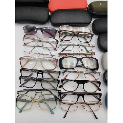 24 - A job lot of glasses with names such as foster grant, hero, allegro frame, impressions and specsaver... 