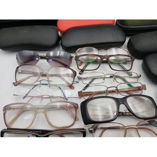 24 - A job lot of glasses with names such as foster grant, hero, allegro frame, impressions and specsaver... 