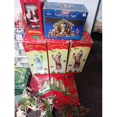 25 - A job lot of Christmas decorations. Featuring, lights, ornaments, a Nativity set, tree decorations, ... 