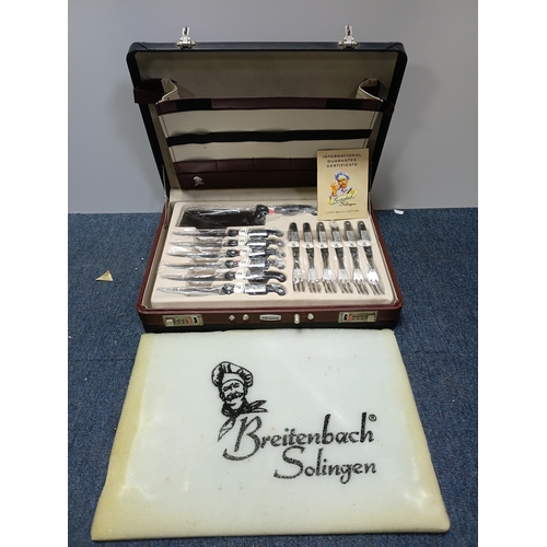 31 - A vintage Breitenbach Solingen deluxe cutlery set housed in a locking briefcase with a certificate a... 