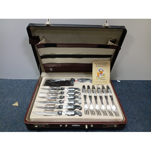 31 - A vintage Breitenbach Solingen deluxe cutlery set housed in a locking briefcase with a certificate a... 