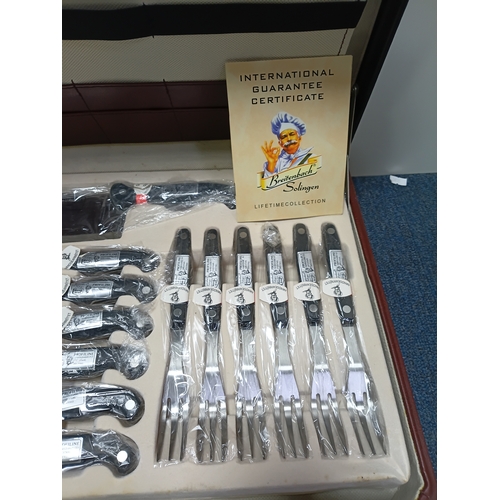 31 - A vintage Breitenbach Solingen deluxe cutlery set housed in a locking briefcase with a certificate a... 